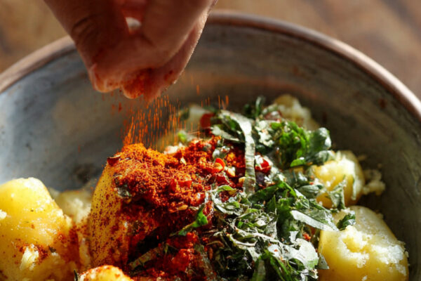 boiled-potatoes-in-a-bowl-being-lightly-mashed-by-