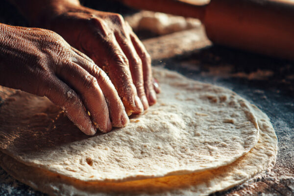 close-up-of-a-stuffed-paratha-being-sealed-by-hand (1)