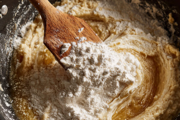 close-up-overhead-shot-of-flour-being-added-to-a-s