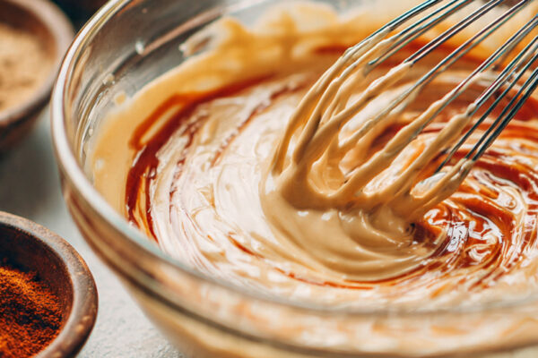close-up-shot-of-a-creamy-smoky-sauce-being-whiske