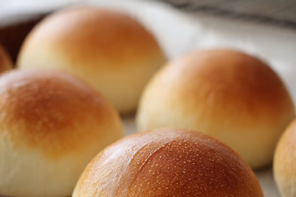 evenly-shaped-round-buns-placed-on-a-parchment-lin