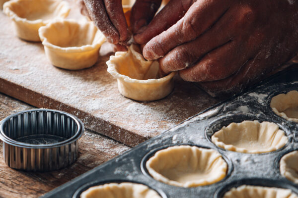 rolled-dough-sheet-on-wooden-surface-with-round-cu