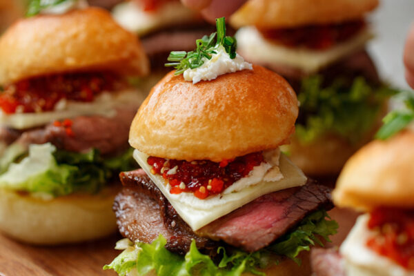 a-close-up-shot-of-hands-assembling-mini-beef-slid