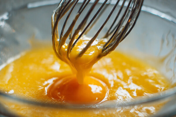 egg-yolks-honey-oil-vanilla-and-milk-being-whisked