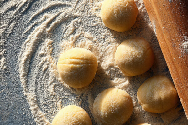 small-balls-of-dumpling-dough-being-rolled-into-th