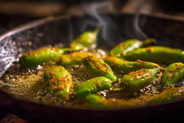stuffed-green-chillies-frying-in-mustard-oil-in-a-